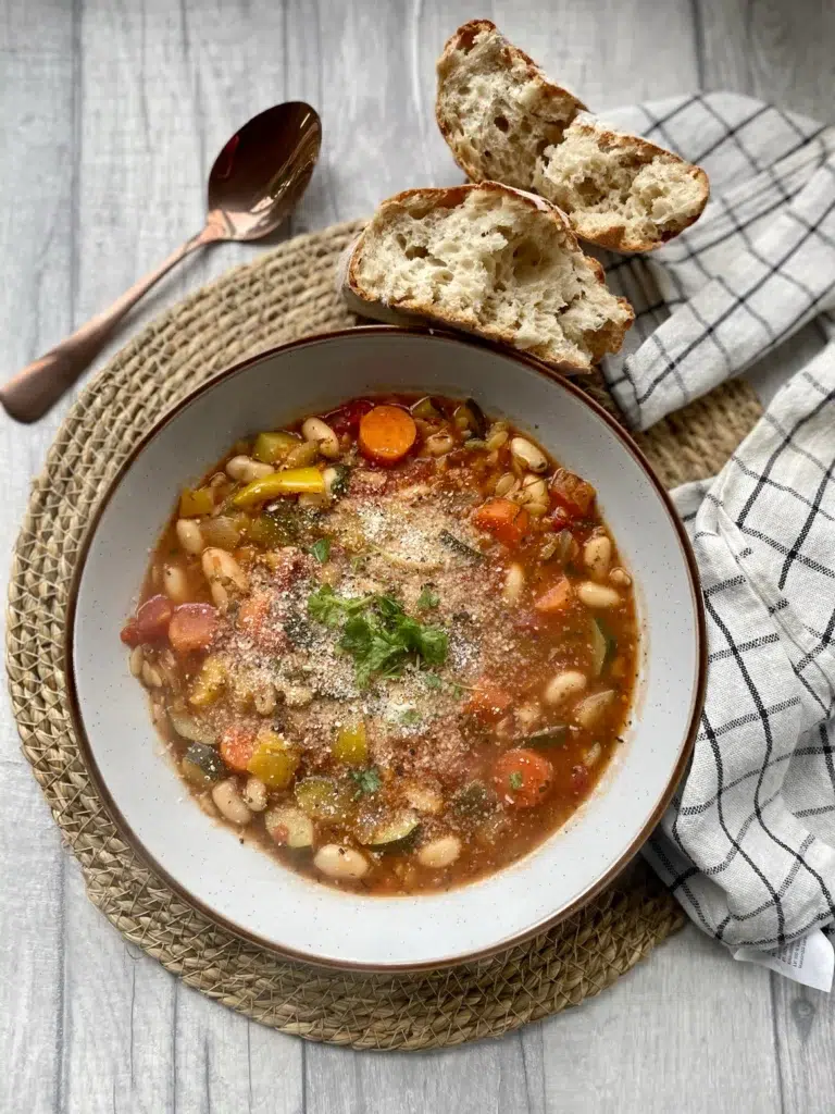 White beans, mixed vegetables and orzo pasta cooked in a herby tomato broth topped with vegan parmesan and a fresh herb garnish
