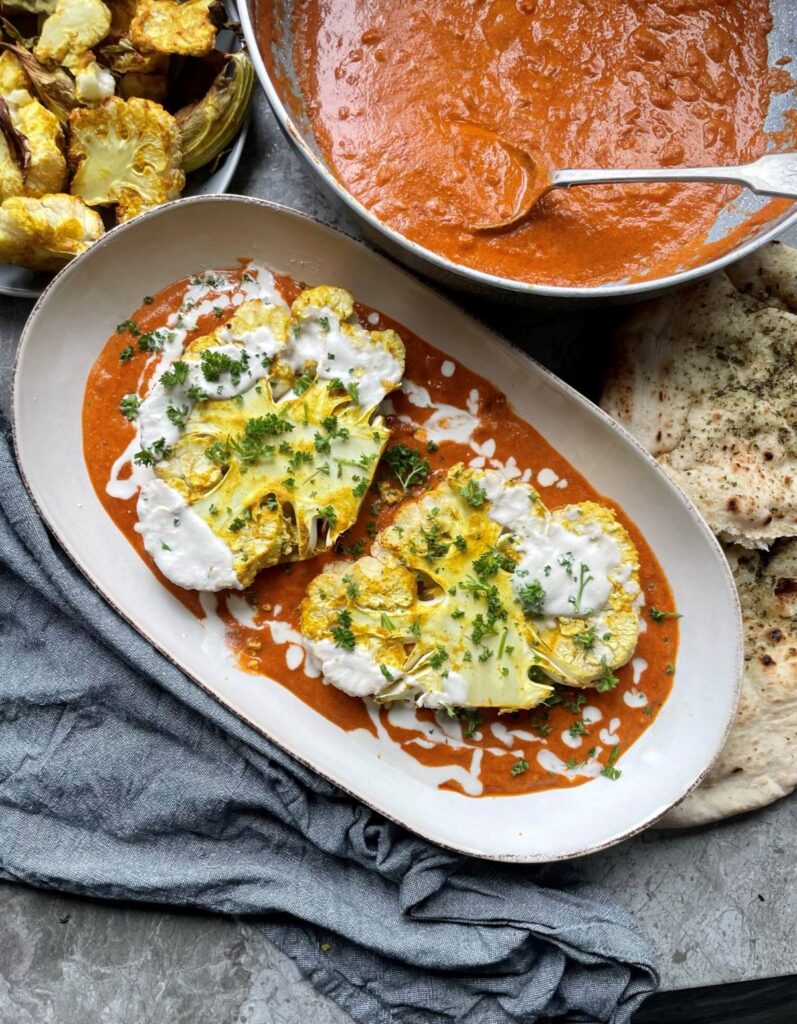 Slow roasted cauliflower steaks in a rich tomato Indian style butter sauce