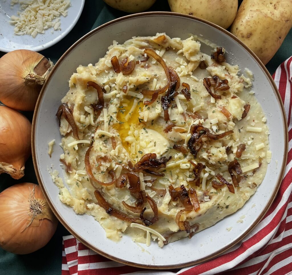 Smooth creamy mashed potato with caramelised onion and cheese