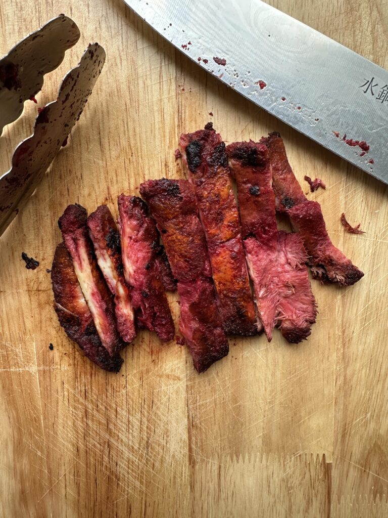Lions mane mushroom steak cut up on a wooden chopping board