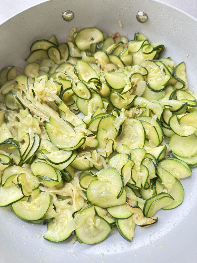 thin slices of courgette and onion cooked until softened