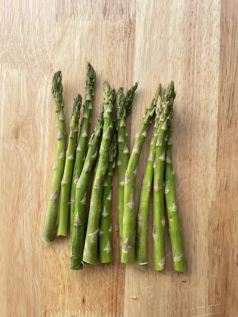 an image of asparagus spears on a wooden background