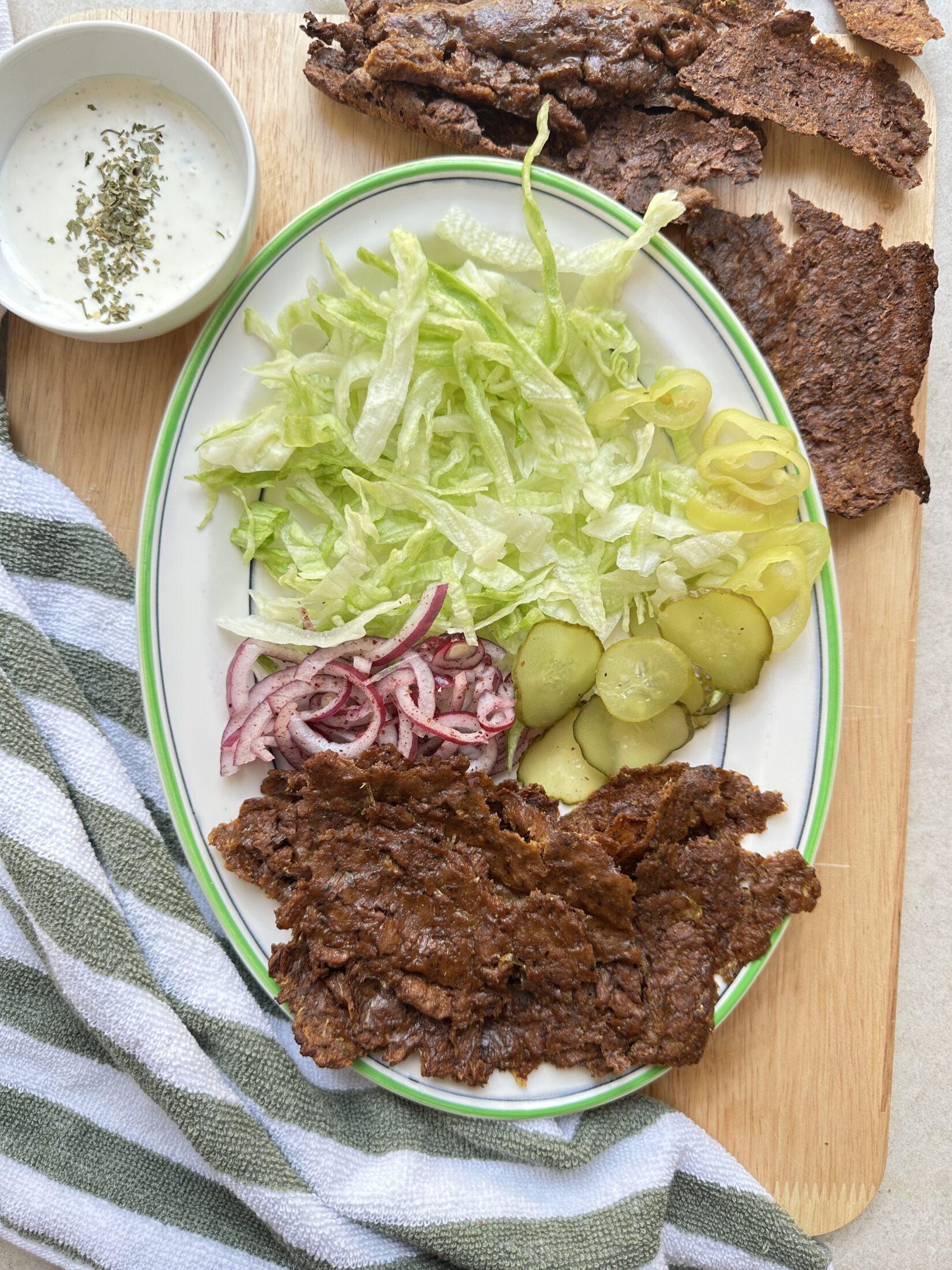 Image of the doner meat cooked along side some salad items ready to make a wrap