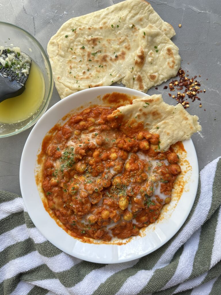 Creamy tomatoey chickpea curry with garlic naan