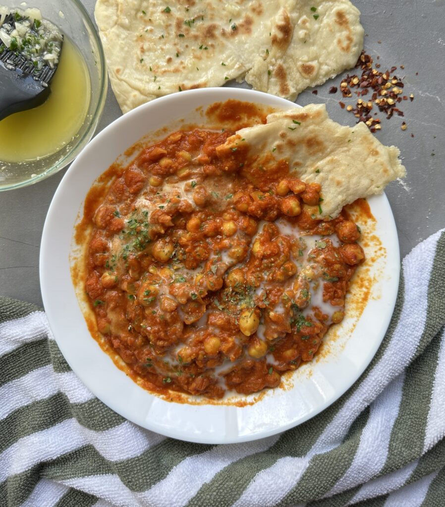 The main final image. Creamy tomatoey chickpea curry with garlic naan