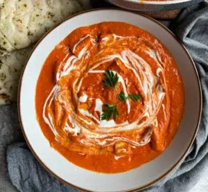 Tempeh pieces in a rich dark orange tikka masala sauce drizzled with a vegan cream topping