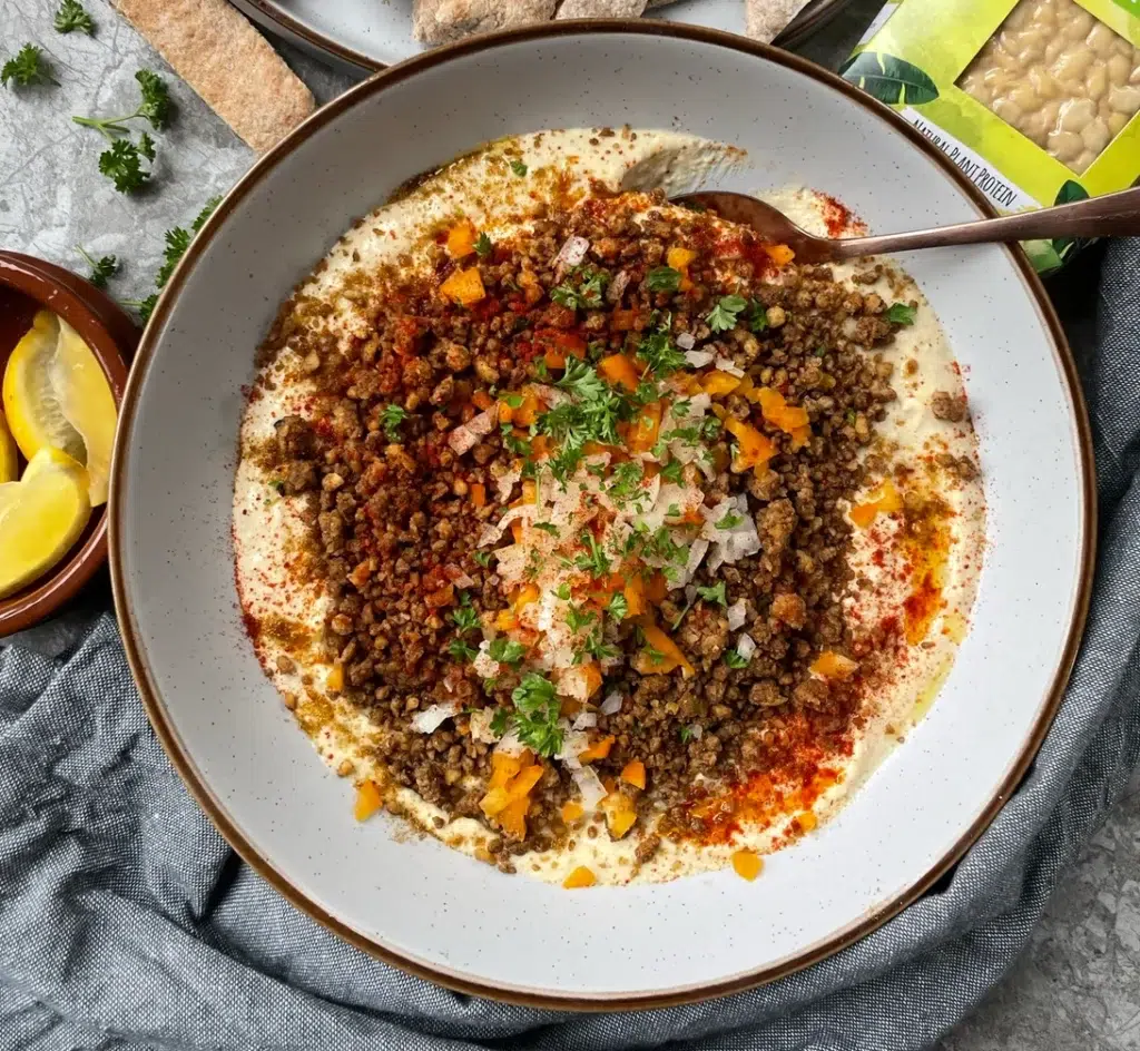 Creamy, smooth hummus topped with a Lebanese spiced tempeh crumble, diced onion, orange pepper and an olive oil drizzle.