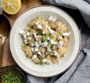 Butter beans cooked in a lemon and herb sauce topped with crumbled vegan feta