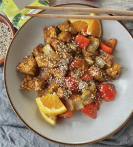 Tempeh pieces, bell pepper and onion in a sweet and savoury sticky orange sauce.
