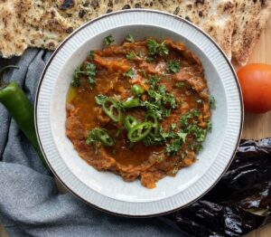 Perfectly spiced Indian style eggplant and tomato dip. Perfect scooped up with fresh naan.