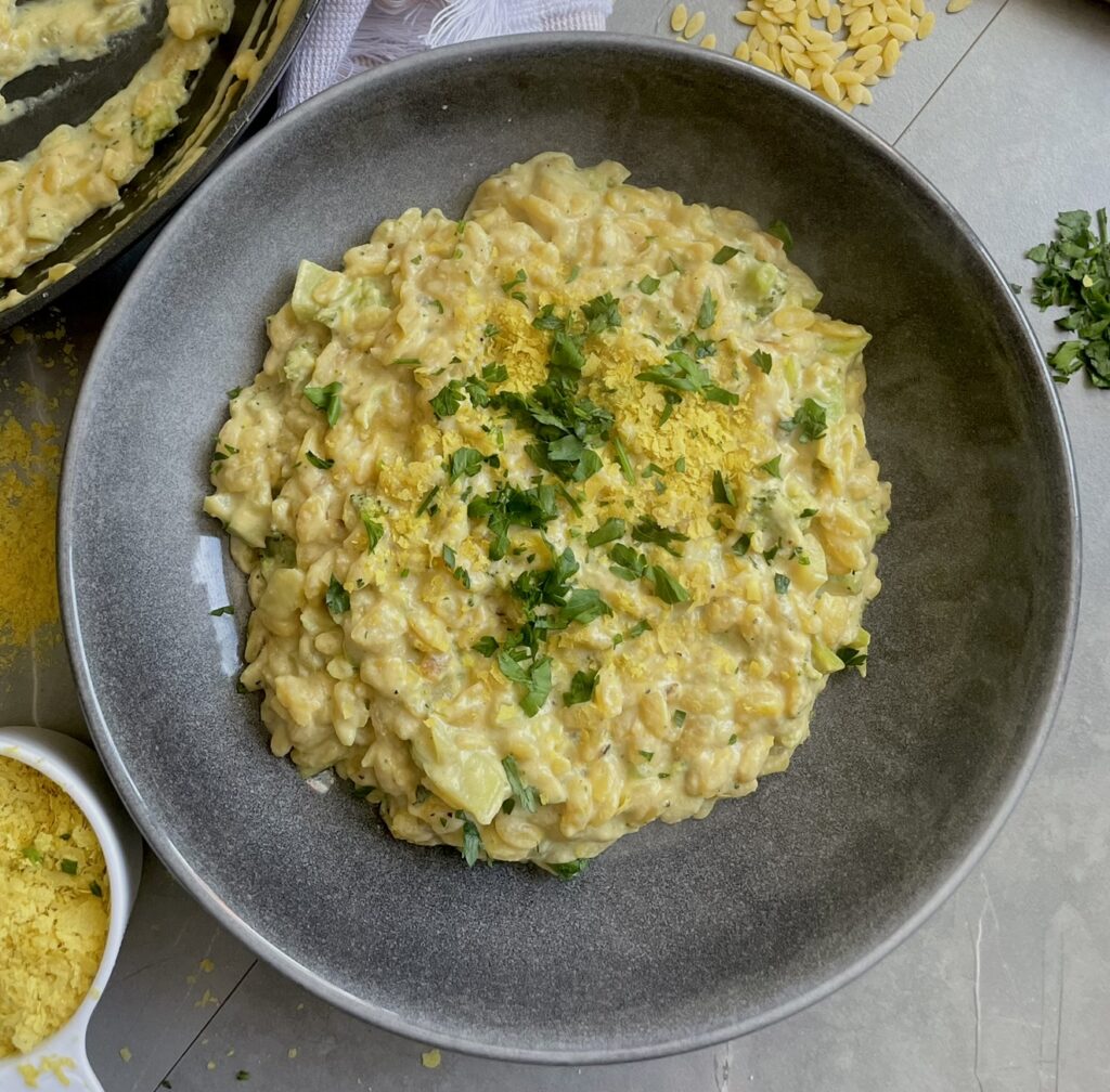 A one pot dish of orzo cooked in a creamy, cheesy sauce with broccoli