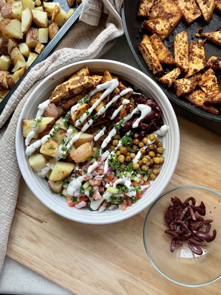 Gyros style tofu, lemon potatoes, roasted chickpeas and chopped salad topped with garlic sauce.