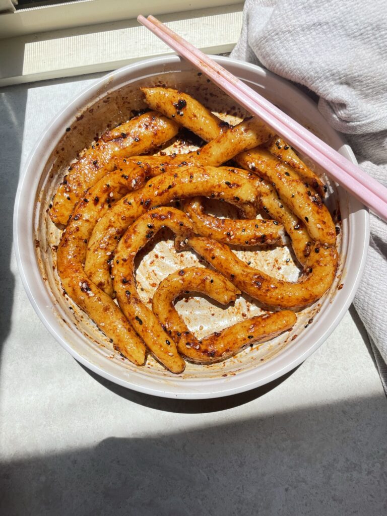 Giant gnocchi noodles in an chinese inspired sauce topped with sesame seeds