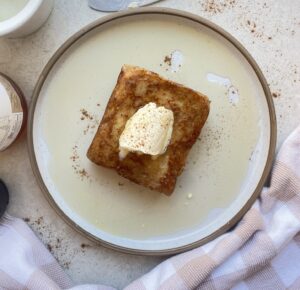 Peanut butter layered bread slices fried to golden perfection in a sweet cinnamon batter topped with butter and syrup