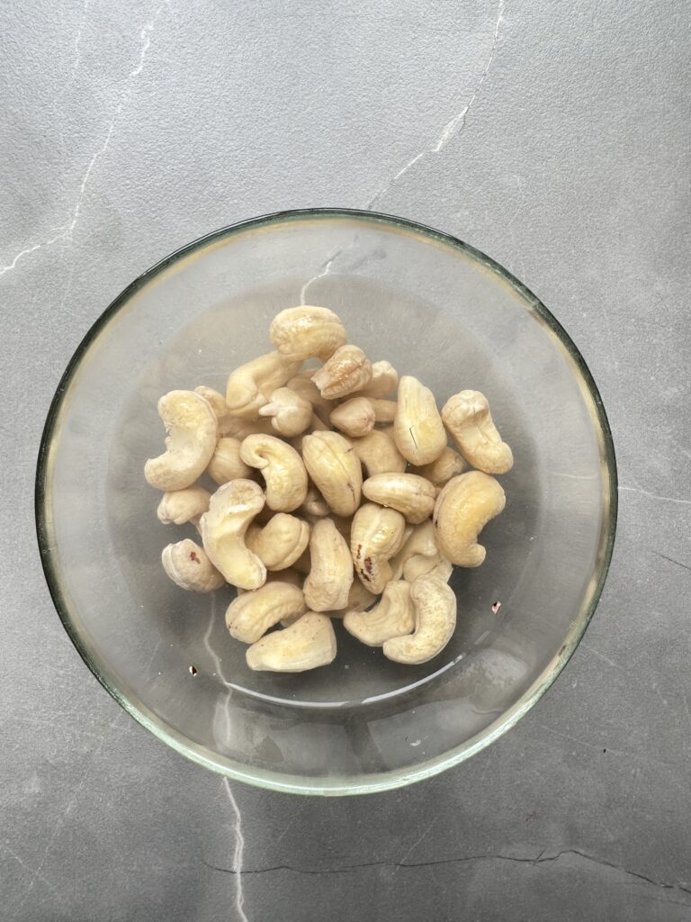 step one of cooking courgette orzo- soak the cashew nuts in boiling water