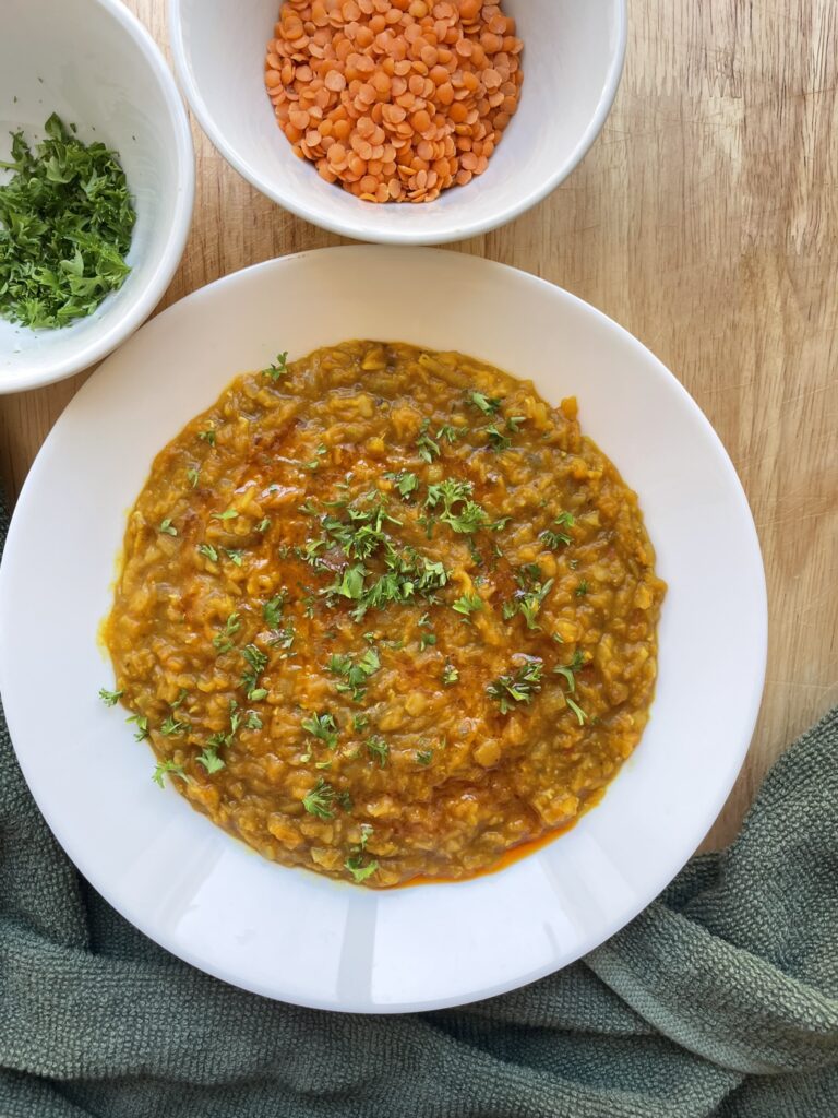 final image of the pumpkin dal with a side of red lentils and chopped parsley