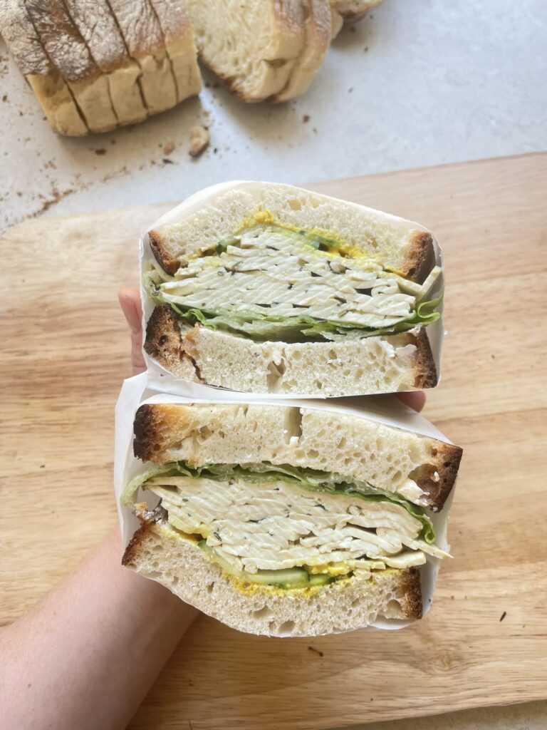a cross section of a sandwich containing the vegan tofu sandwich meat