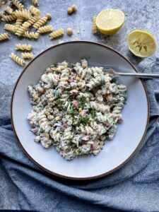 Pasta coated in a creamy mayonnaise dressing with crushed chickpeas, chopped salad and nori flakes. served topped with fresh parsley and a squeeze of lemon juice