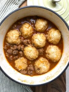 Vegan beef stew and dumplings in a Dutch oven
