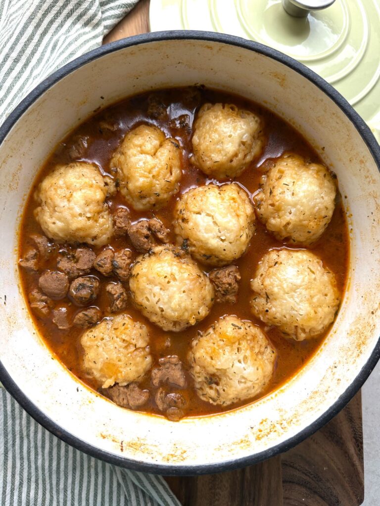 Vegan beef stew and dumplings in a Dutch oven