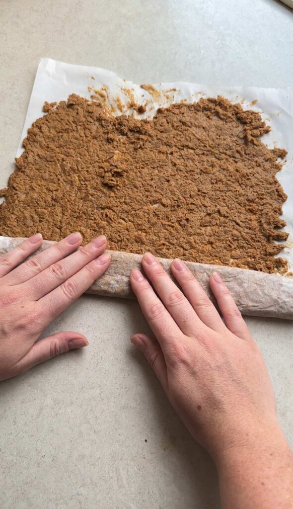 rolling up the doner meat in a sheet of baking paper